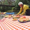 guide preparing riverside picnic during WAVE rafting tour in Manuel Antonio