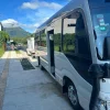 modern shuttle van parked near San Jose, Costa Rica, with Arenal Volcano in the background
