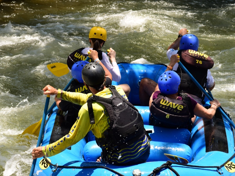 Group braving a rapid drop on an Arenal rafting tour.