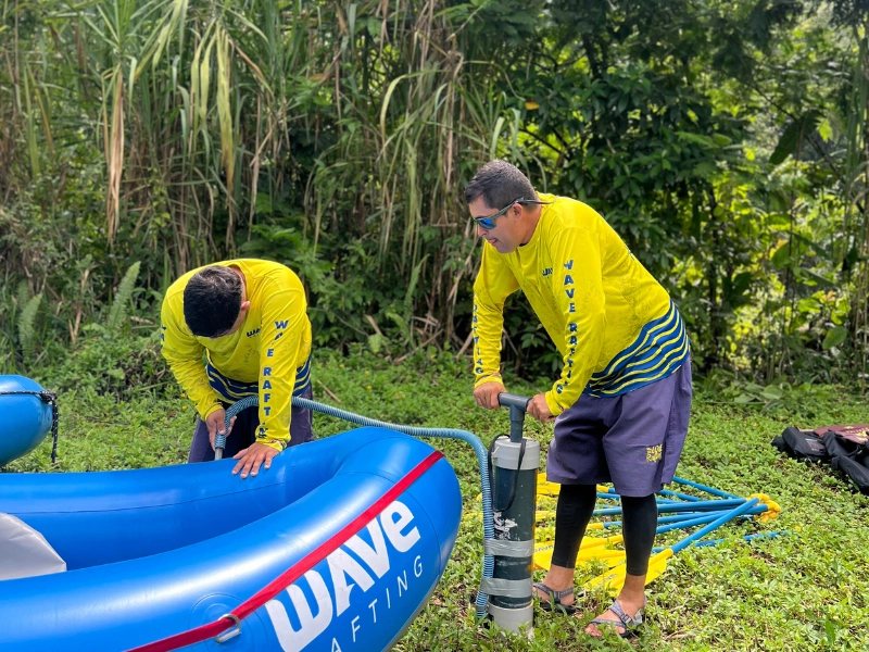 Guides inspecting gear before an Arenal rafting tour.