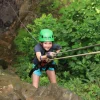 Young girl canyoning with helmet and harness – family-friendly adventure with Wave Rafting
