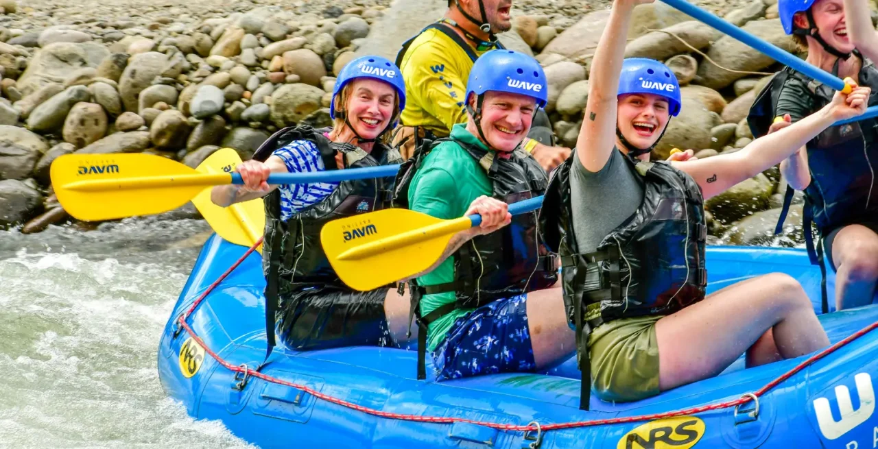 Family with kids enjoying a fun whitewater rafting tour in Arenal, Costa Rica