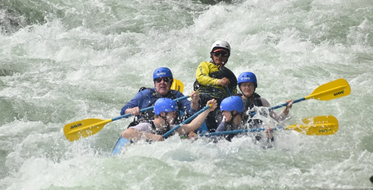 Group navigating intense whitewater rapids in La Fortuna with Wave Expeditions